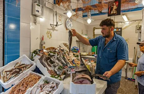 Local market visit and small-group cooking class with lunch at a local's home in Lucca